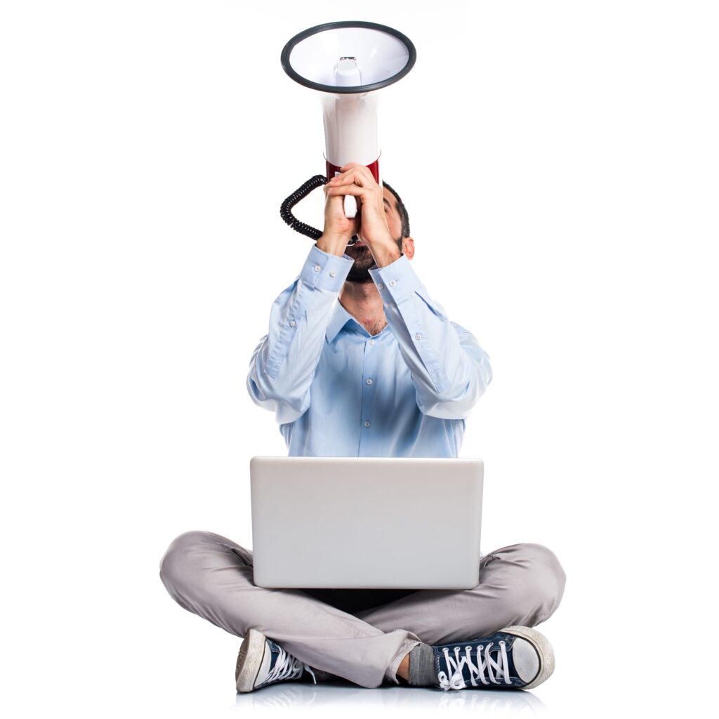 man with laptop shouting by megaphone